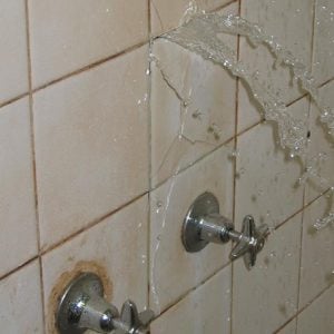 Examples of failure of health hardware in wet areas. Burst breach behind tiles from hard water.